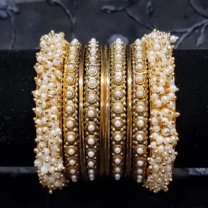 Gold metal bangles set with ivory and golden kangan bangles with pearls